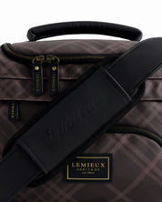 Close-up view of the padded strap on the Cocoa LeMieux Heritage ProKit Lite Grooming Bag on a plain background