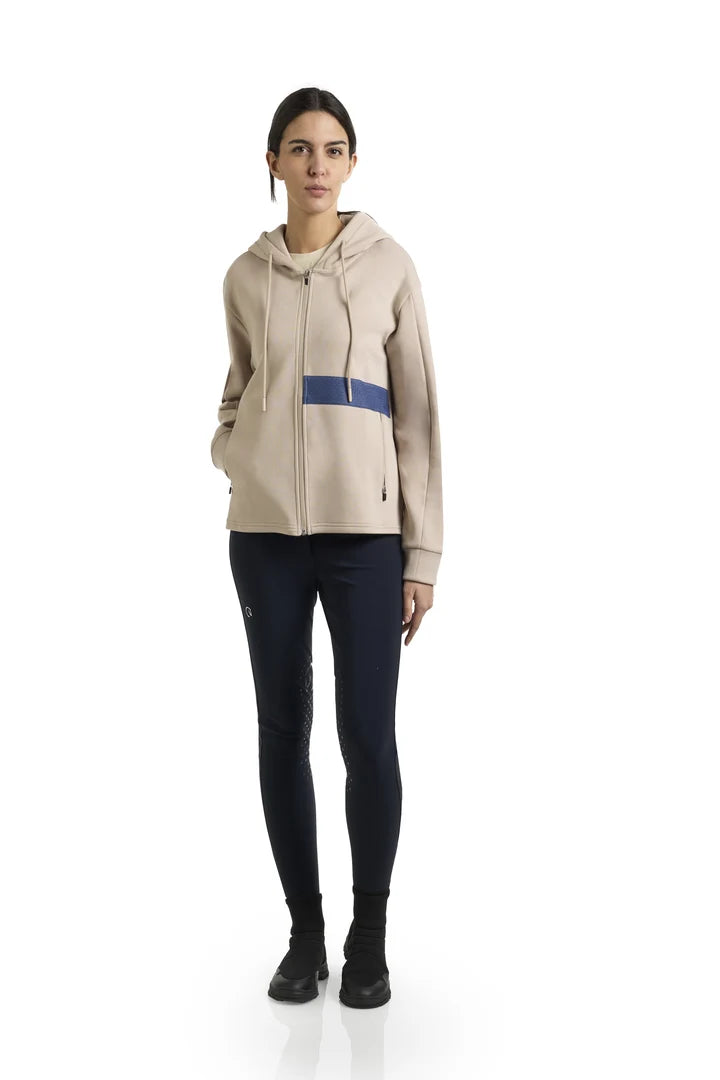 Light tan full zip hoodie with blue stripe detailing and drawstrings shown on model on plain white background