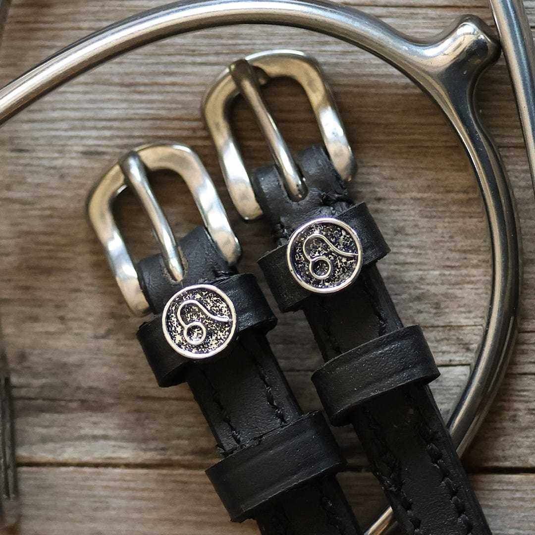 View of the Leo Mane Jane Spur Straps on a wood background