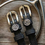 View of the Libra Mane Jane Spur Straps on a wood background