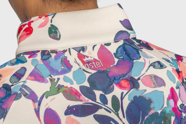 Closeup back view of a model wearing the Kastel Amethyst Watercolor Floral Scuba 1/2 Zip Pullover showing the Kastel logo below the collar
