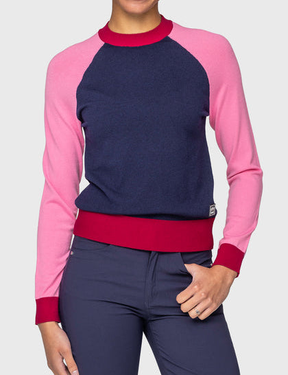 Front view of a model wearing the navy, hot pink, and wine Kastel Crewneck Sweater on a plain background