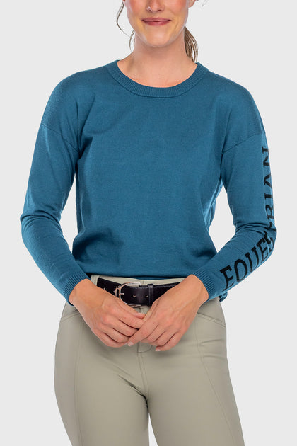 Front view of a female model wearing the Sailor Blue Kastel Crewneck Sweater on a plain background