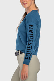 Side view of a female model wearing the Sailor Blue Kastel Crewneck Sweater on a plain background