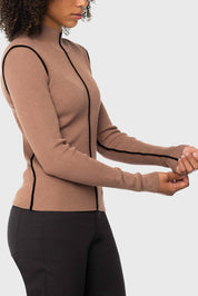 Side view of a model wearing the Kastel Chocolate Brown Mock Neck Ribbed Sweater on a plain background