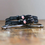 View of the Pigs Fly Mane Jane Spur Straps  on a wood table