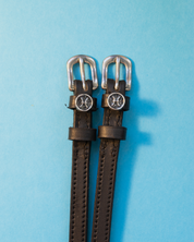 View of the Pisces Mane Jane Spur Straps on a blue background