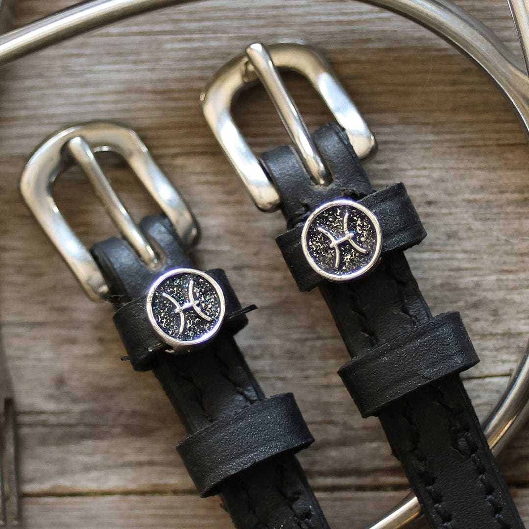 View of the Pisces Mane Jane Spur Straps on a wood background