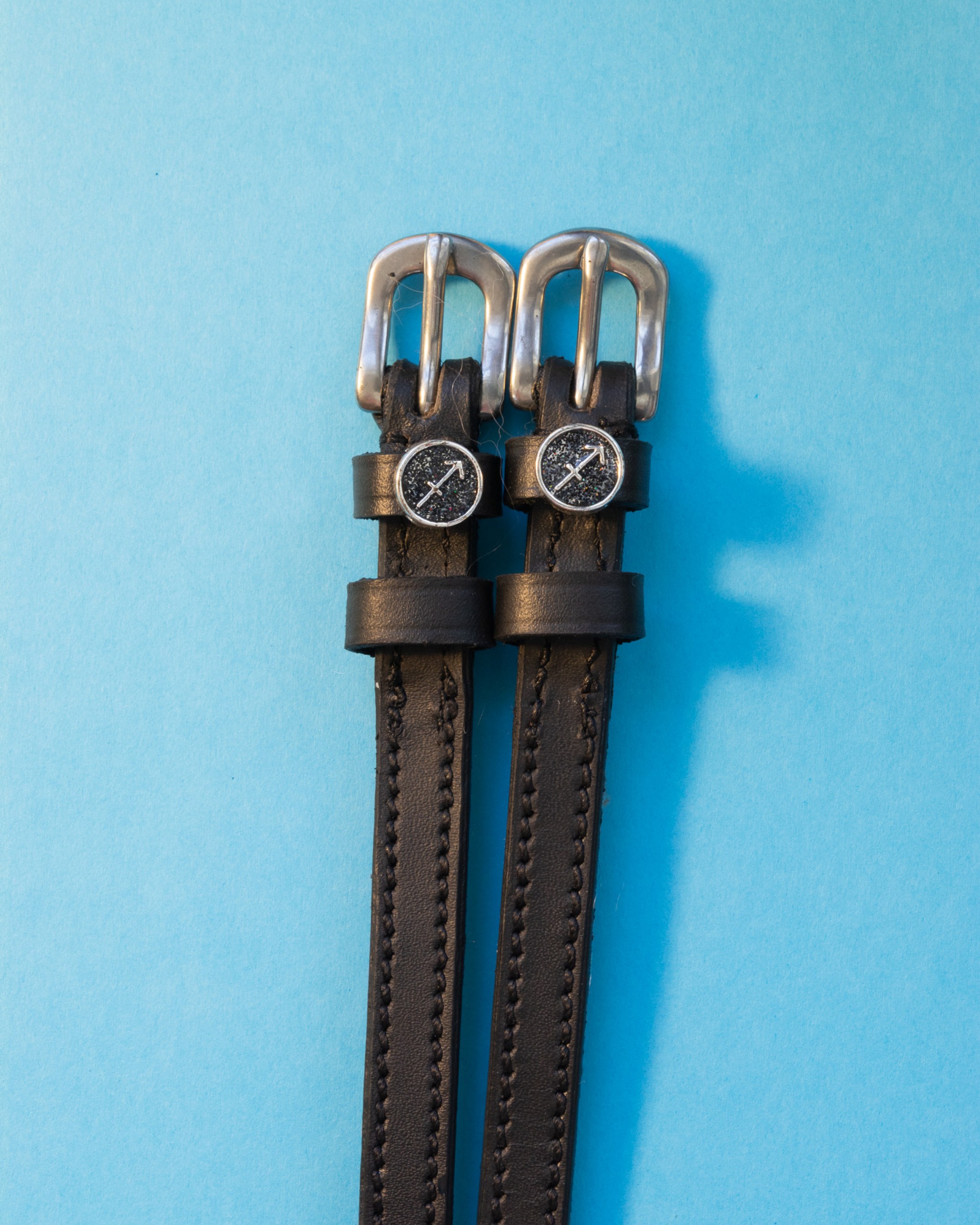 View of the Sagittarius Mane Jane Spur Straps on a blue background