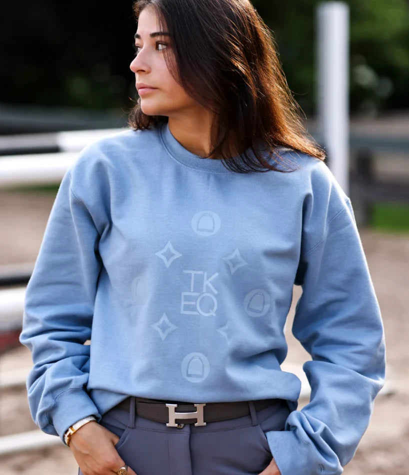 Light blue crewneck sweatshirt with tonal monogram logo on the front shown on model