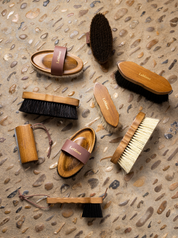 View of an assortment of Lemieux brushes on a stone background