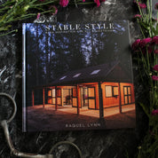 Front view of the Stable Style Book-Volume I on a marble and flower background