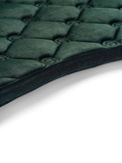 Close-up view of the spine on the Sycamore Green Equestrian Stockholm Velvet Jump Saddle Pad on a plain background