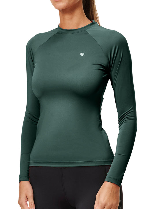 Front view of a female model wearing the Sycamore Green Equestrian Stockholm Dynamic Long Sleeve Base Layer on a white background
