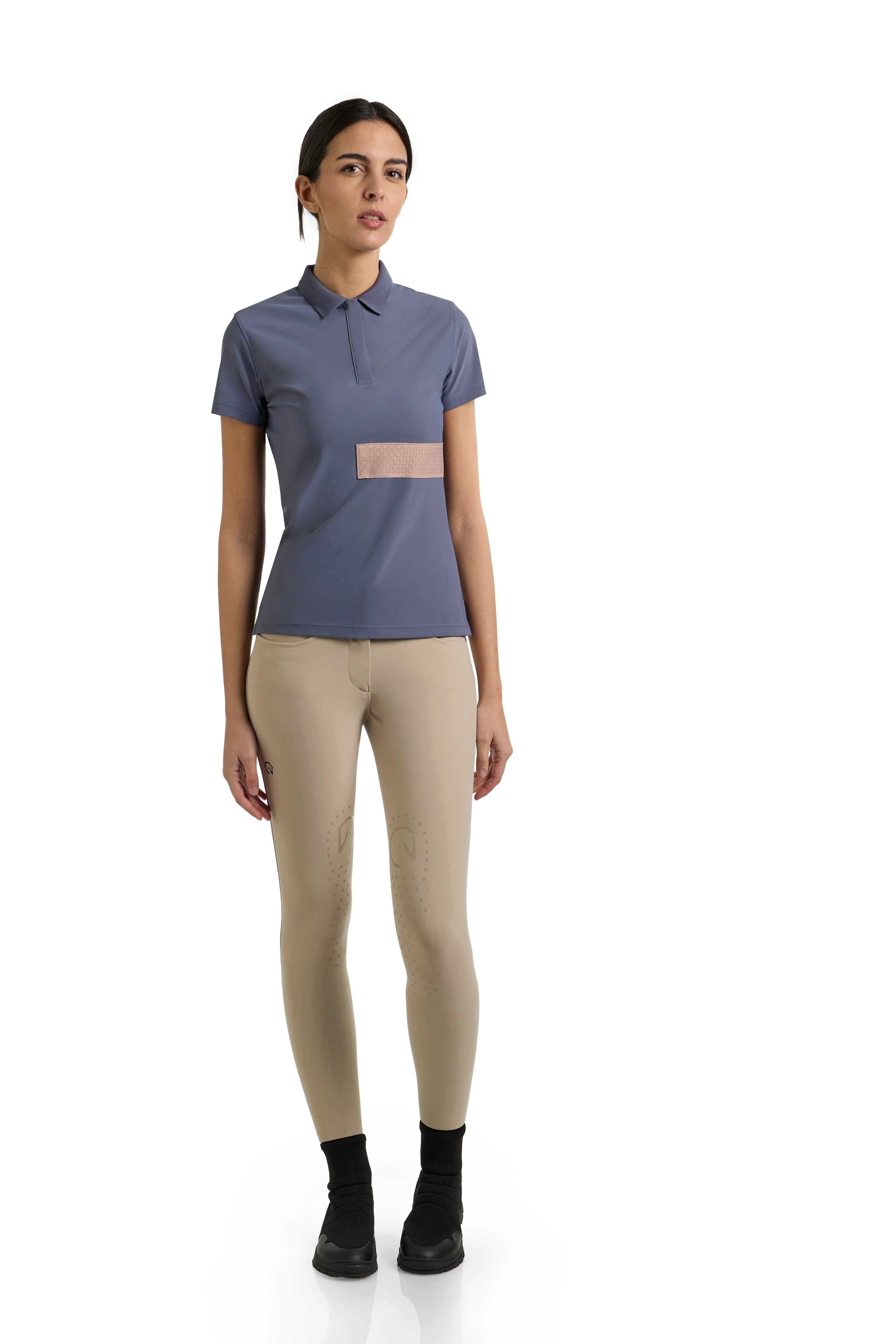 Light blue polo top with collar and tan stripe accent shown on model