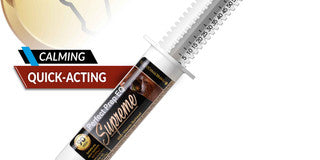 Syringe-like container with gold cap and 'Supreme' branding on a white background