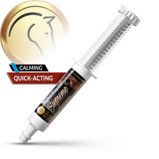 Syringe-like container with gold cap and 'Supreme' branding on a white background