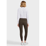 Full body back view of a female model wearing the Mocha Samshield Chloe 3D Full Grip Breeches and white shirt on a plain background