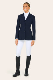 Full body front view of a model wearing the navy RJ Classics Victory Show Coat, white breeches, and black tall boots on a plain background