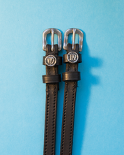 View of the Virgo Mane Jane Spur Straps  on a plain blue background