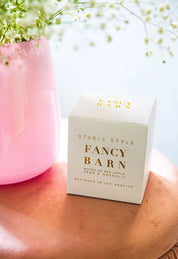 Angled front view of the packaging for the Fancy Barn Stable Style Soy Wax Candle