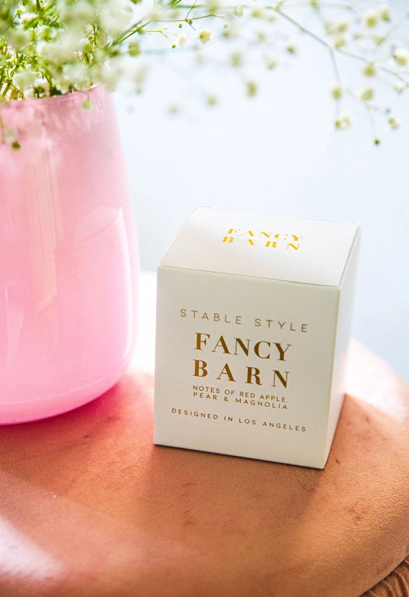 Angled front view of the packaging for the Fancy Barn Stable Style Soy Wax Candle