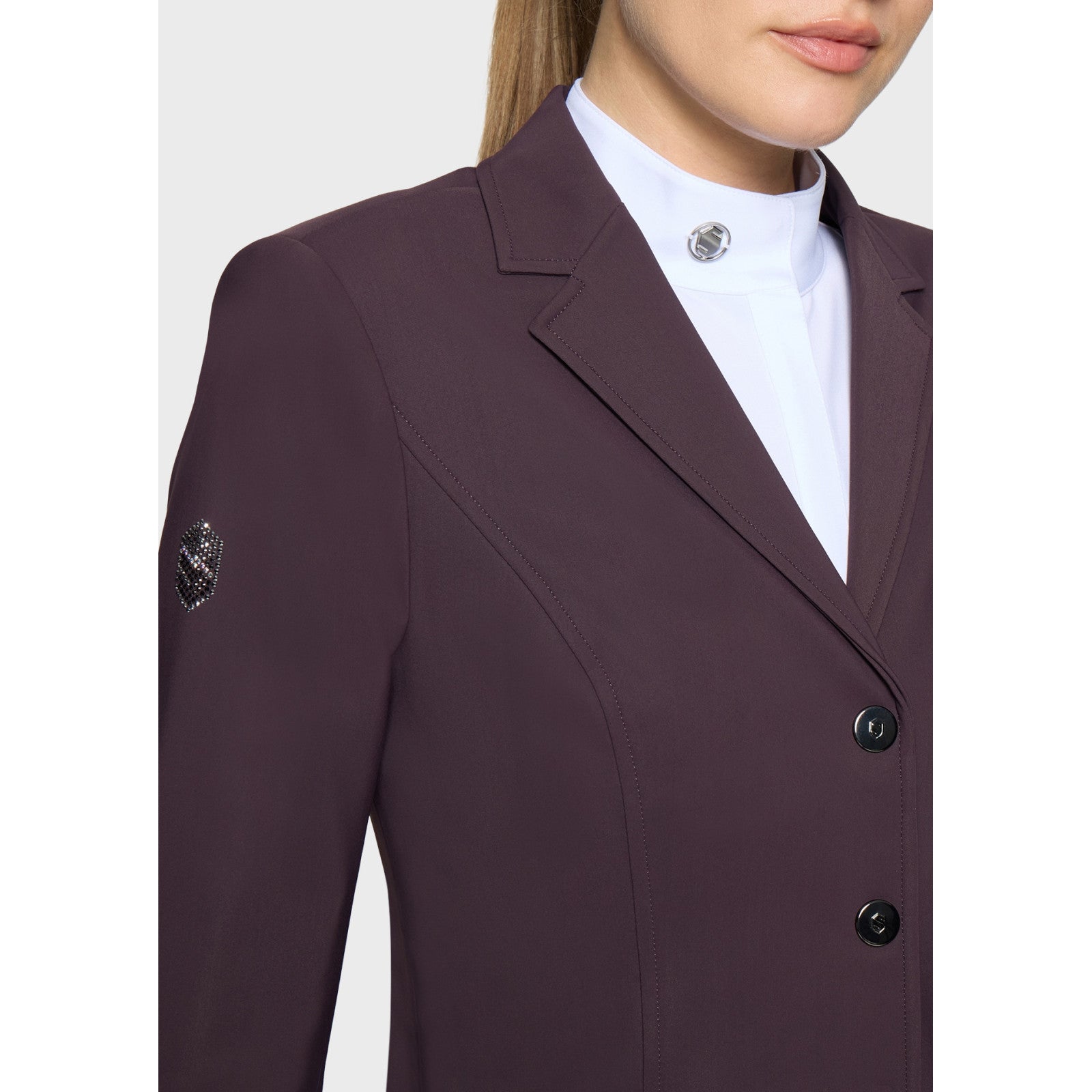 Close-up front view of a female model wearing the Black Cherry Samshield Alexia Show Coat on a plain background