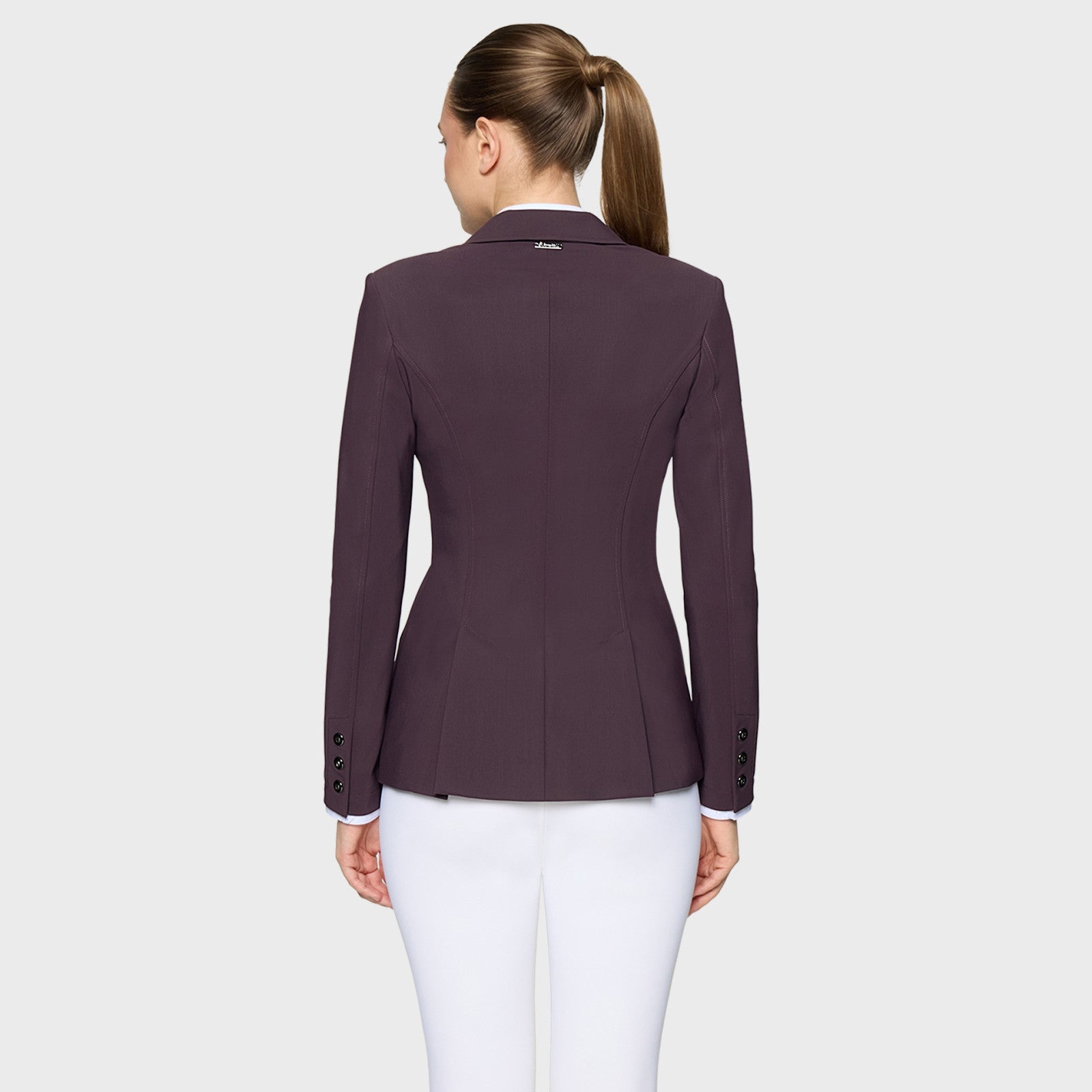 Back view of a female model wearing the Black Cherry Samshield Alexia Show Coat on a plain background