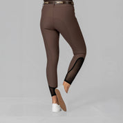 Back view of a model wearing the Dark Brown Equinavia Maud Tech Knee Patch Breeches on a plain background