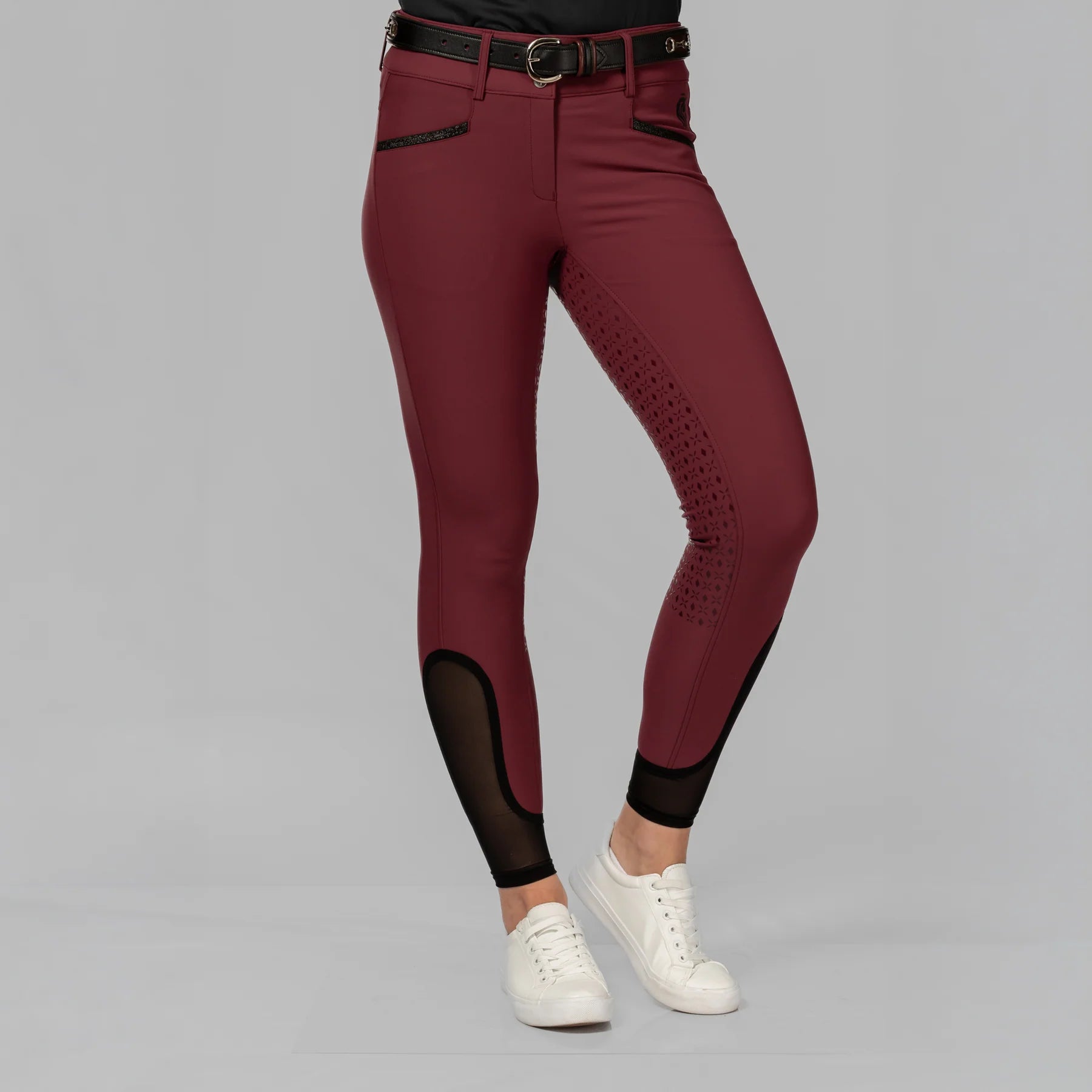 Front view of a model wearing the Burgundy Equinavia Kristina Full Seat Breeches on a plain background