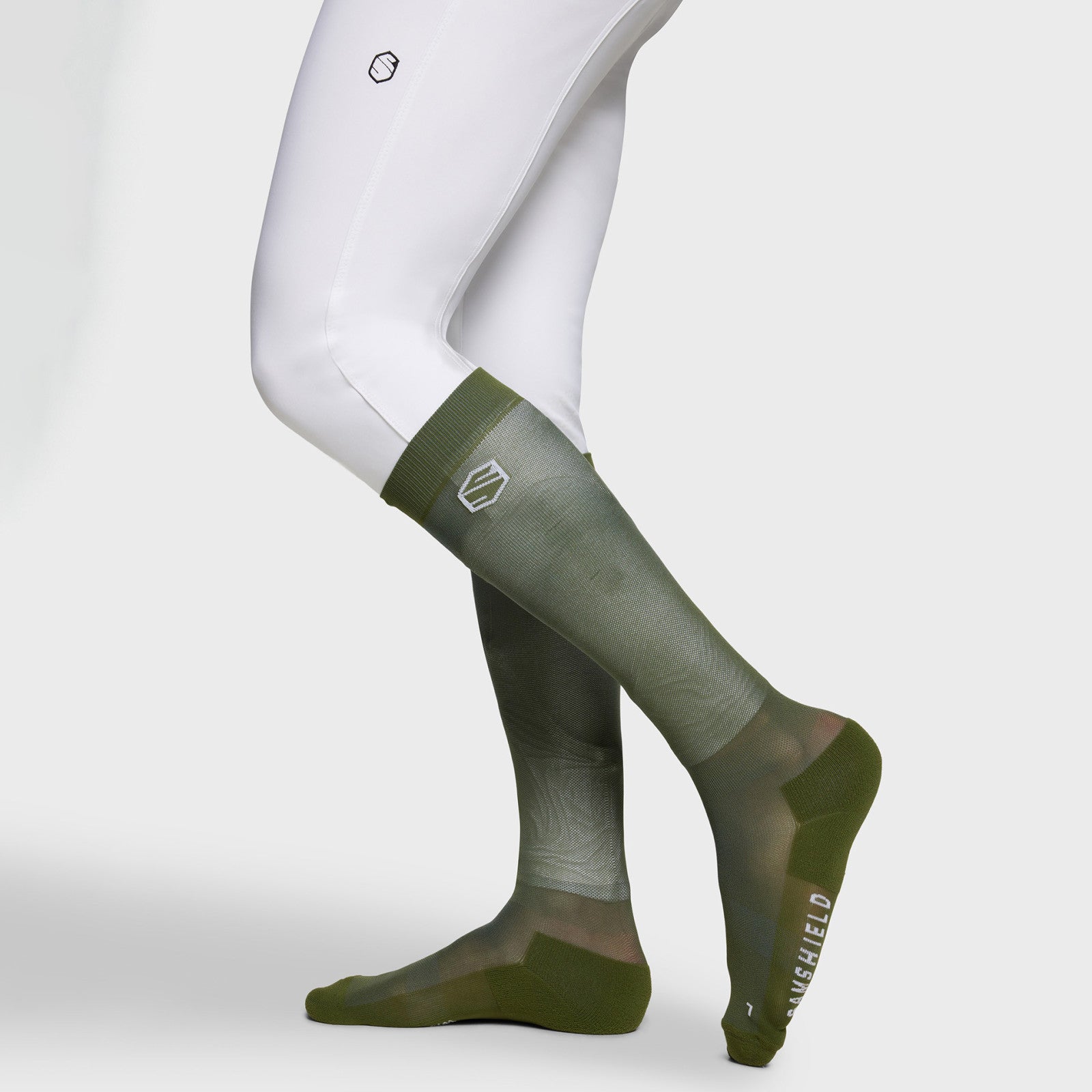 Side view of a model wearing the Dark Forest Samshield Balzane Trio Socks on a plain background