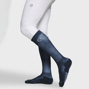 Side view of a model wearing the Navy Samshield Balzane Trio Socks on a plain background