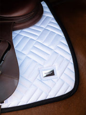 Side view of the back of the Black Edition Equestrian Stockholm Modern White Jump Pad as worn by a horse