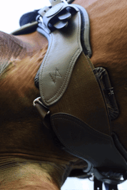 Underside view of the brown Total Saddle Fit StretchTec Shoulder Relief Girth – Jump as worn by a horse