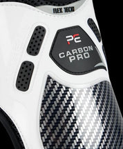 Close-up view of a white Premier Equine Carbon Pro Fetlock Boot on a black background