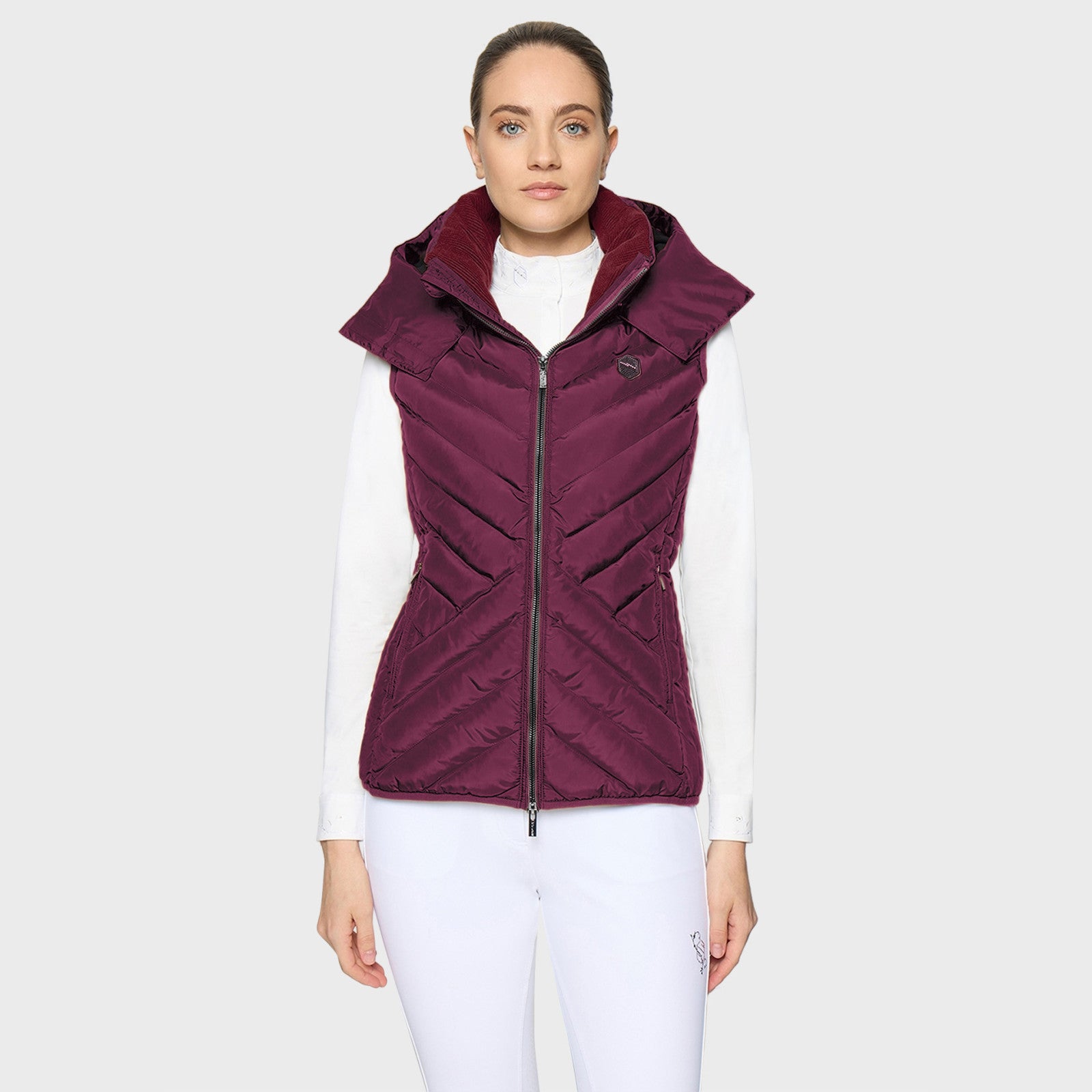 Front view of a female model wearing the Plum Samshield Chamonix Puffer Vest on a plain background