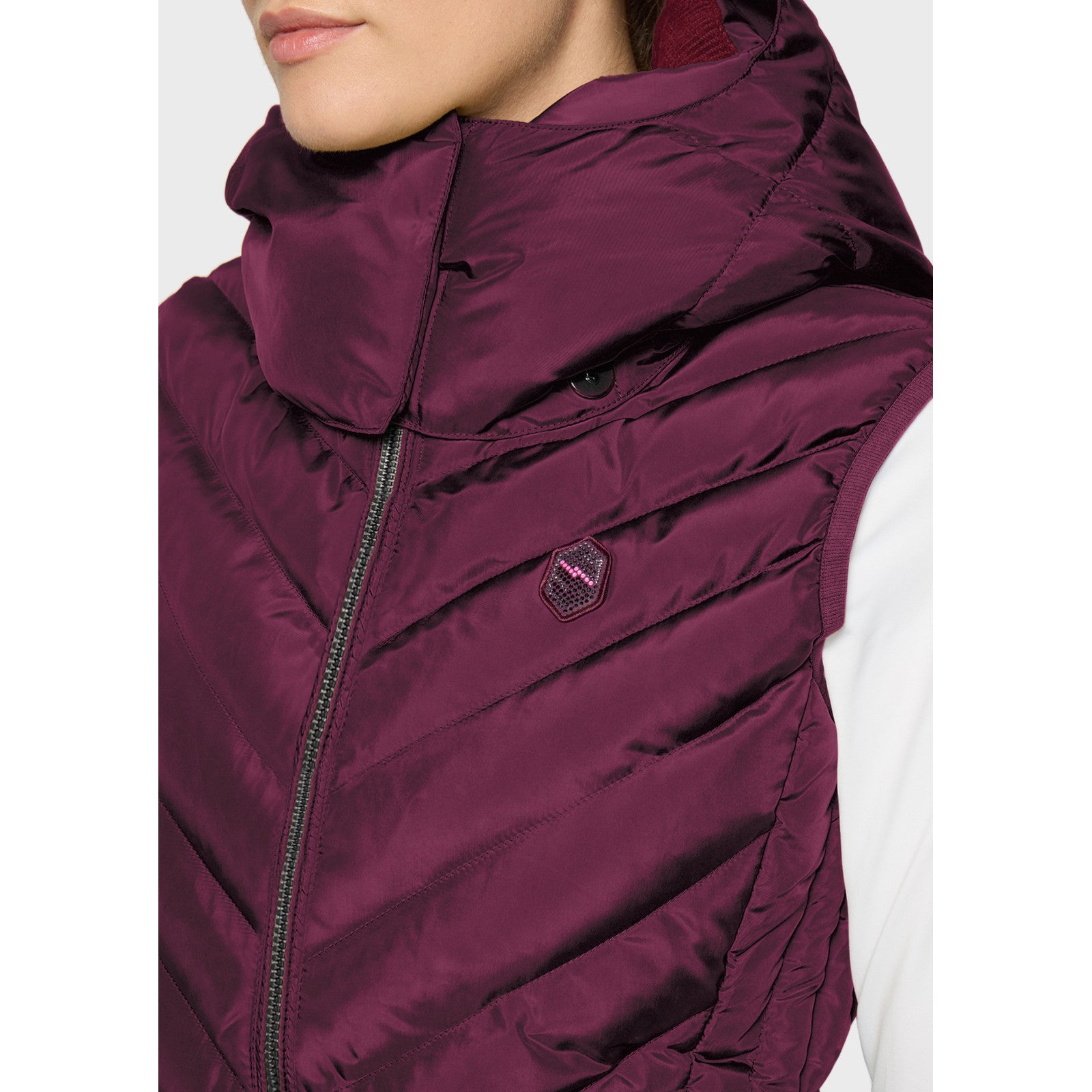 Close-up front view of a female model wearing the Plum Samshield Chamonix Puffer Vest on a plain background