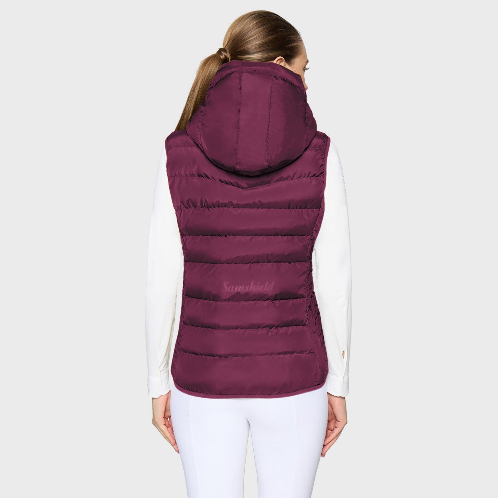 Back view of a female model wearing the Plum Samshield Chamonix Puffer Vest on a plain background