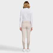 Full body back view of a female model wearing the Beige Samshield Chloe 3D Knee Grip Breeches with a white shirt on a plain background