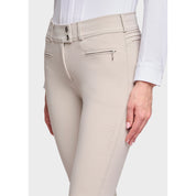 Close-up angled front view of a female model wearing the Beige Samshield Chloe 3D Knee Grip Breeches on a plain background