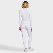 Full body back view of a female model wearing the White Samshield Chloe 3D Full Grip Breeches with a white shirt on a plain background