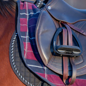Close-up side view of a bay horse wearing the Burgundy/Navy Equinavia Norse Fleece Quarter Sheet under a brown jump saddle
