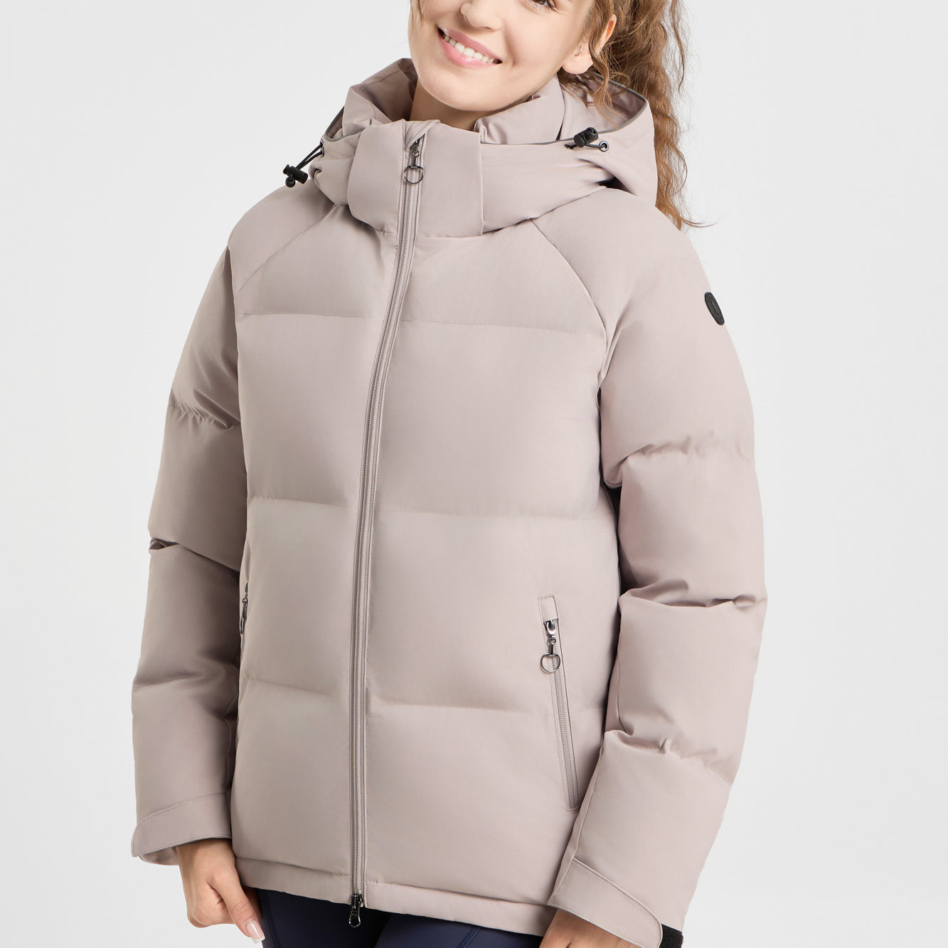 Front view of a female model wearing the Atmosphere Horze Dina Puffy Padded Jacket on a plain background