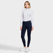 Full body front view of a female model wearing the Navy Samshield Delice Floral Full Grip Breeches with white shirt on a plain background