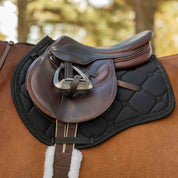 Side view of a horse wearing the Black Equinavia Bergen Crystal All Purpose Pad under a brown saddle