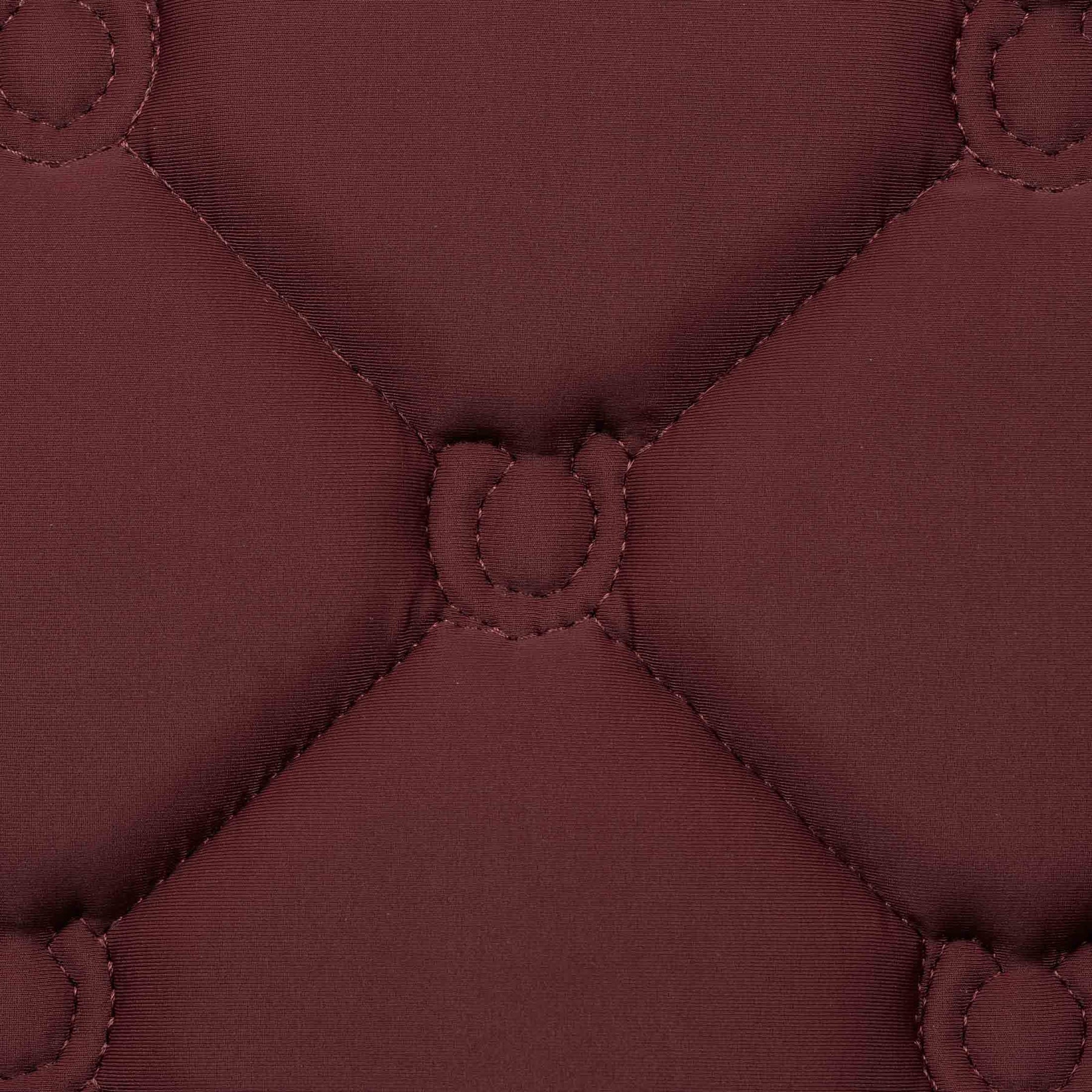 Close-up view of the quilting on the burgundy Equinavia Bergen Crystal All Purpose Pad