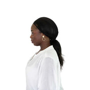 Side view of a female model wearing the Black Ellsworth Ponytail Hairnet on a white background