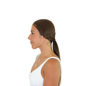 Side view of a female model wearing the Dark Brown Ellsworth Ponytail Hairnet on a plain background