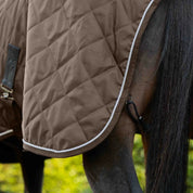 Brown fabric quilted stable blanket with faux fur neck lining shown on horse