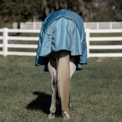 Back view of a horse wearing the Equinavia Thunder 360 200g Detachable Neck Turnout Blanket outdoors
